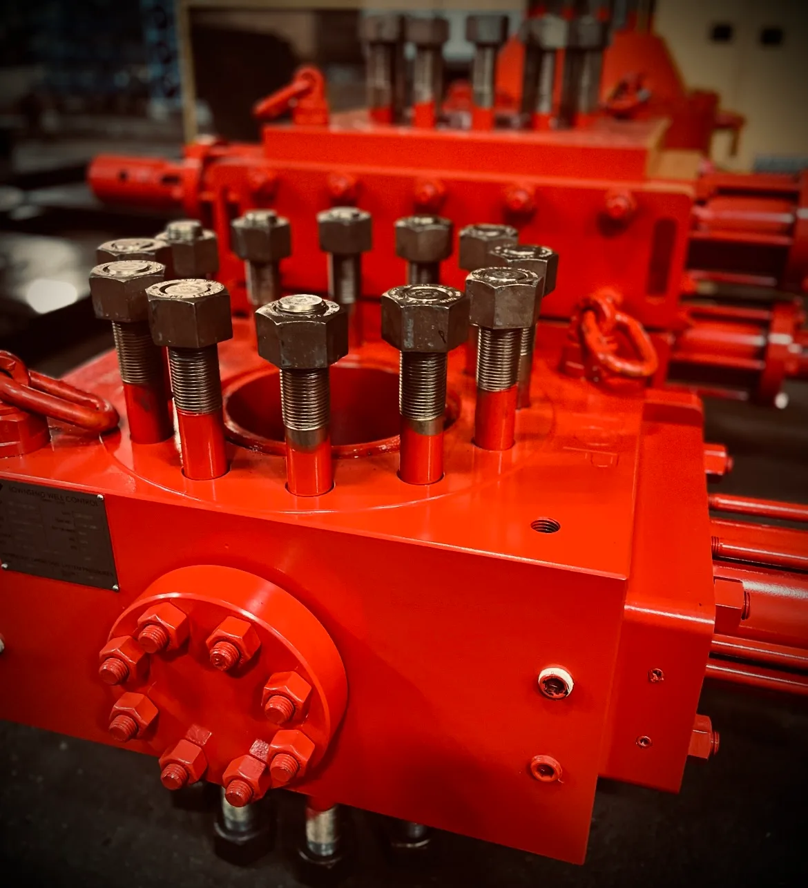 Townsend Well Control shear BOP, painted red, studs and ram housing close up